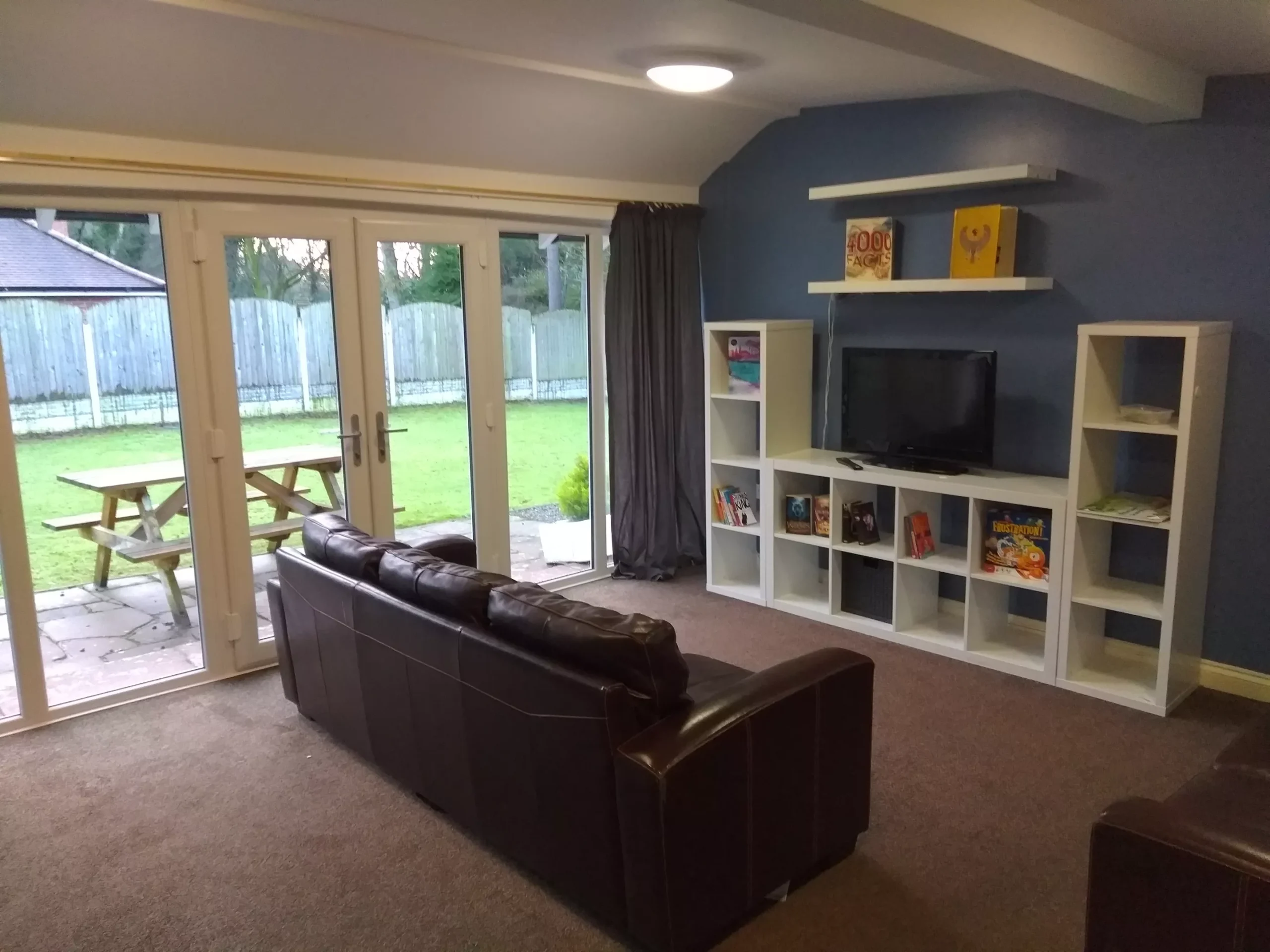 Woodend House sitting room with sofa and TV