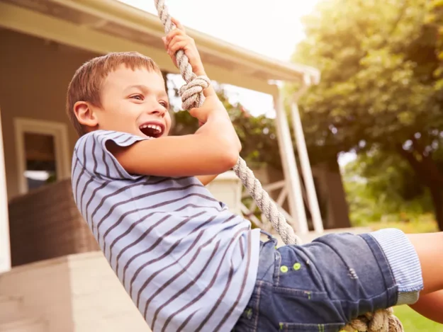 Young person having fun on a rope swing