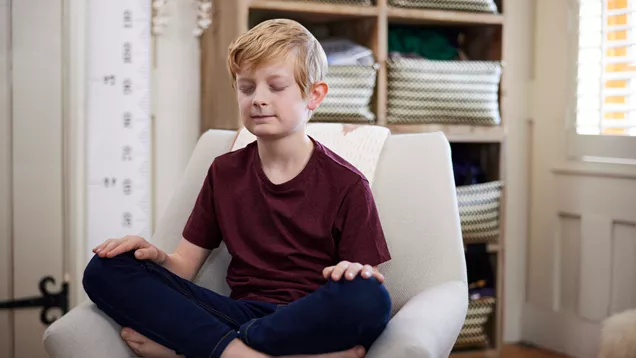 Young person sitting calmly on a sofa