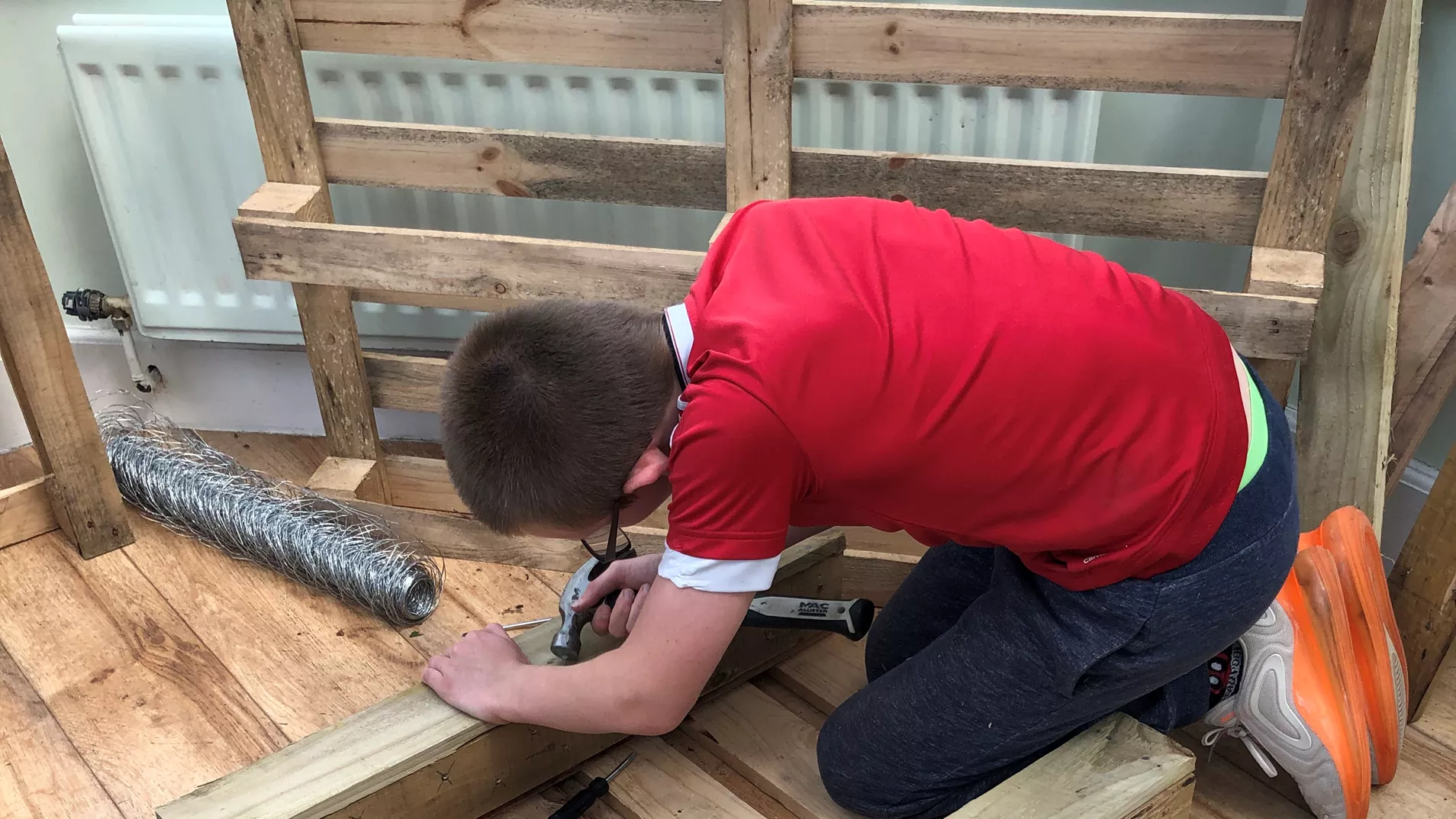 Young person building furniture at a North Lakes home