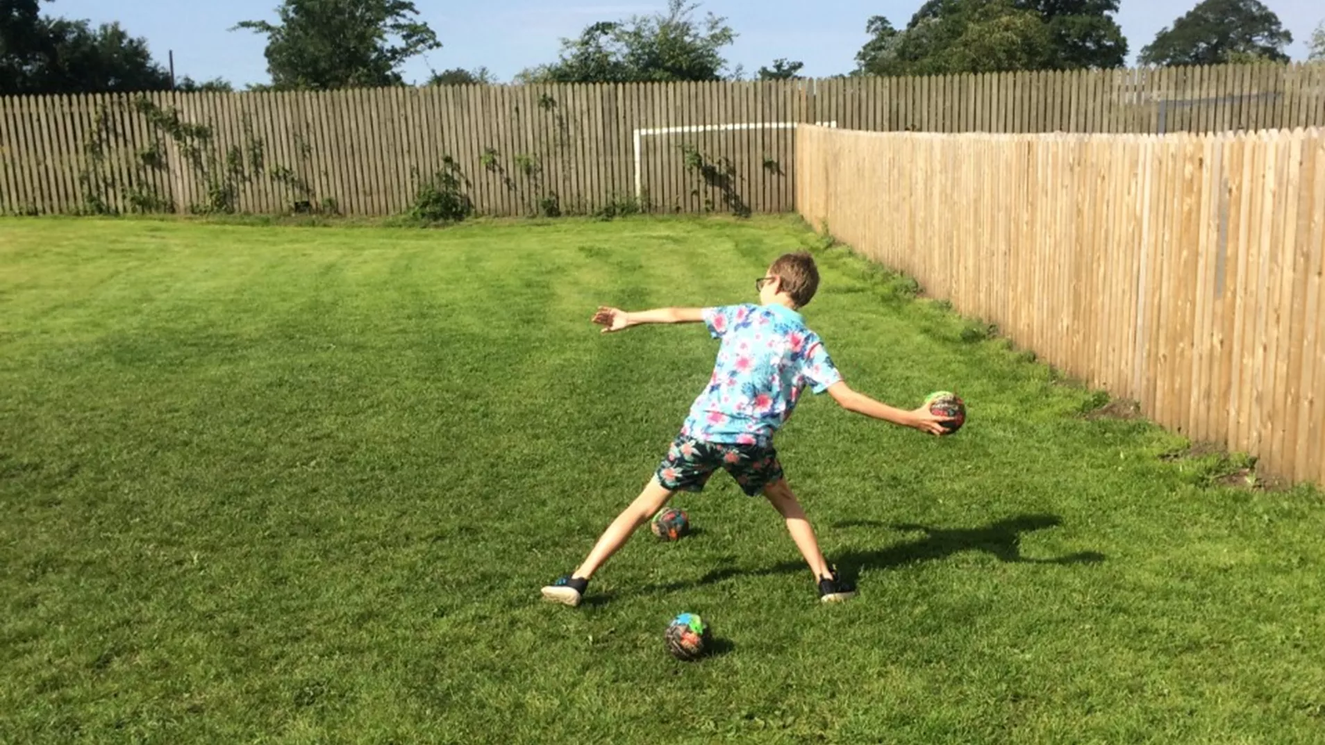 Young person playing dodge ball at a North Lakes home