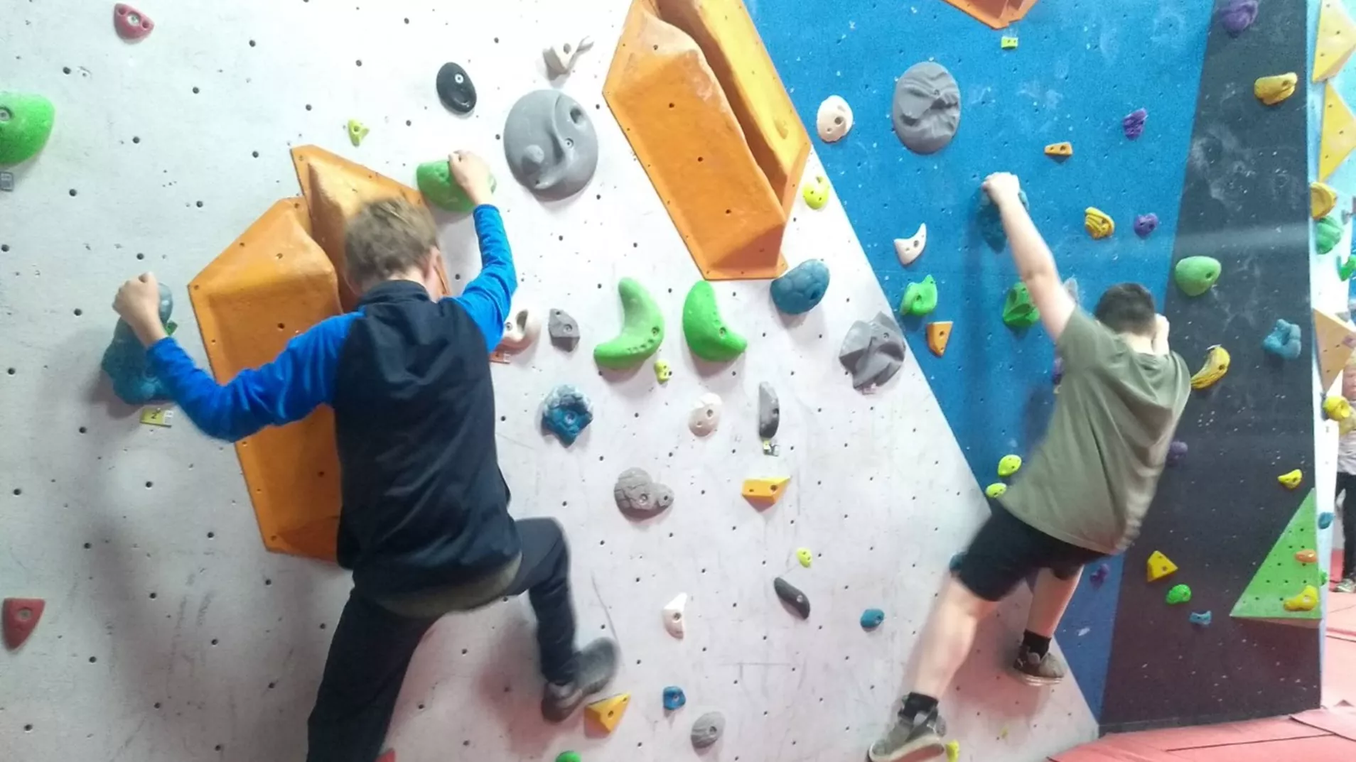 Young people on a rock climbing wall at North Lakes