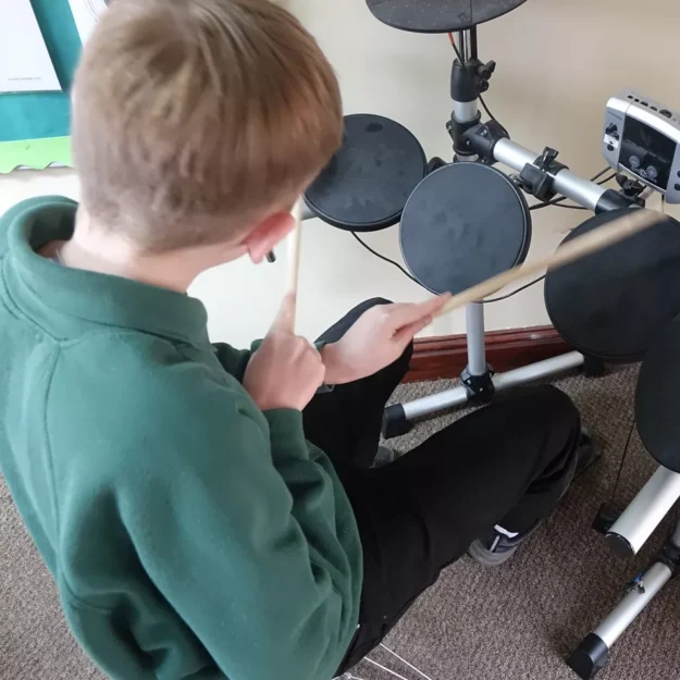 Kirby Moor school pupil playing on an electronic drum kit