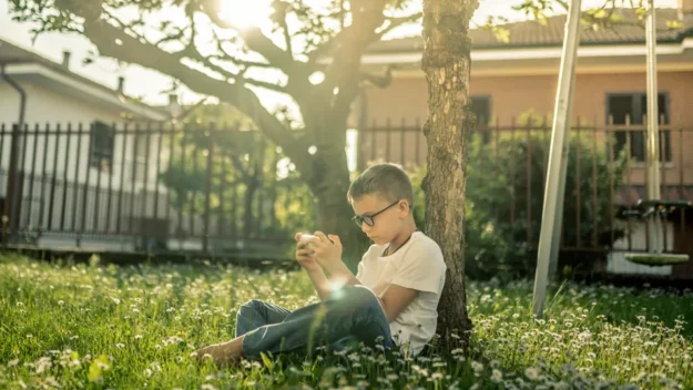 Young person playing alone outside